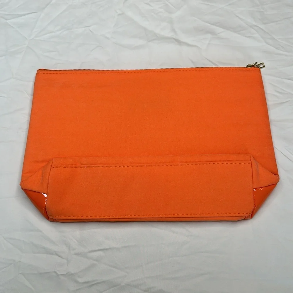 BEAND NEW! Vibrant Orange Cosmetic Bag with Glossy Finish and Zipper Closure.